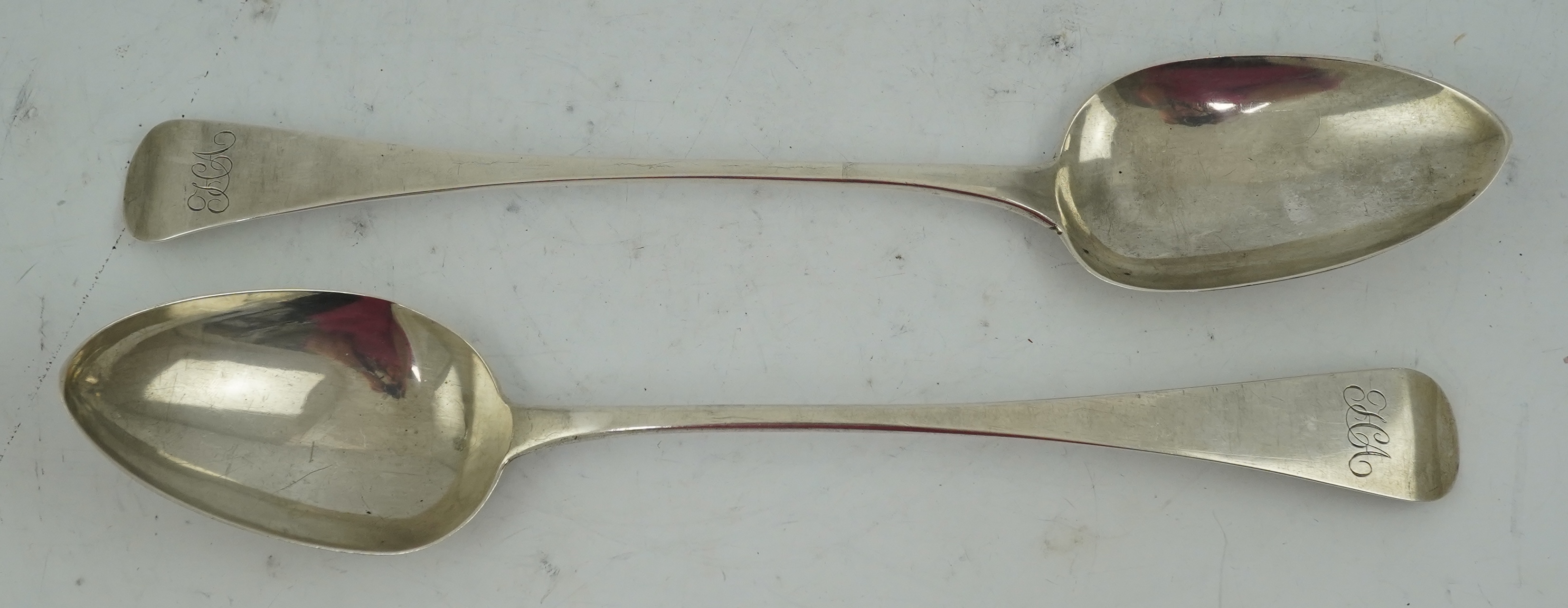 A George III provincial silver Old English pattern basting spoon by George Murray, Newcastle, 1824, 30.3cm, together with a similar George IV provincial silver basting spoon, by Barber, Cattle & North, York, 1827, 29cm